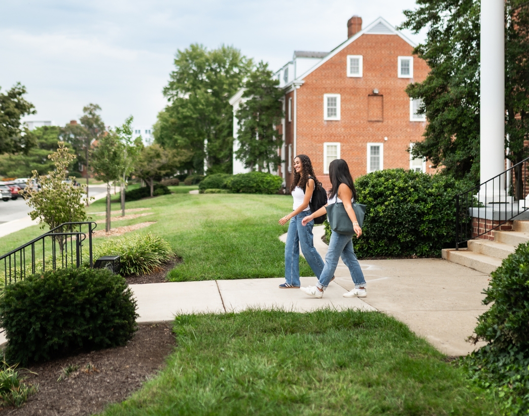 Two girls walking on sidewalk near Texas A&M.