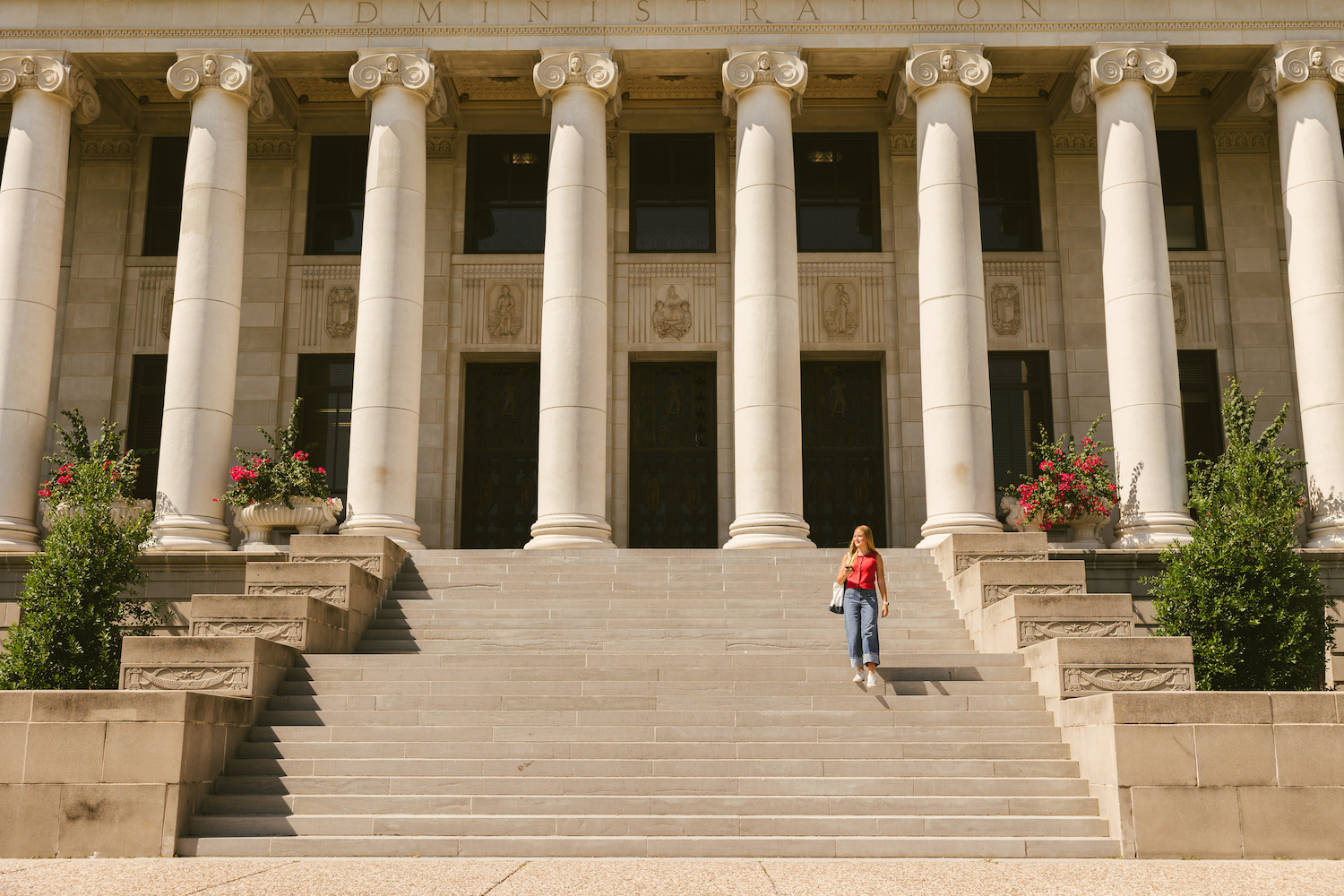 Girl walking down the stairs of the Administration office on Texas A&M campus