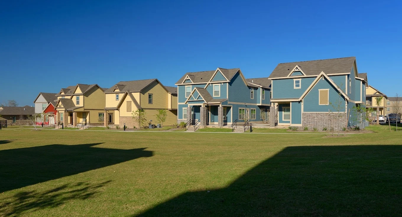 Redpoint College Station cottage-style student housing building with front porches and landscaped green space.